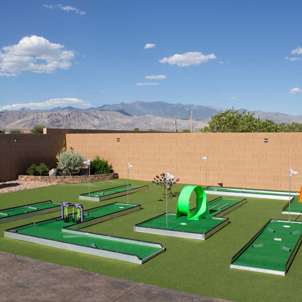 Miniature golf course with a vibrant putting green and obstacles available for rent in Dallas, TX