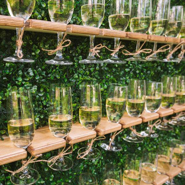 Elegant wine glasses on a wall, featuring a champagne wall for events in Dallas, TX