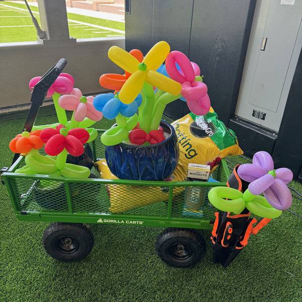 A Small Trolley with Balloons Highlighting Custom Balloons Artists Services in Dallas, TX
