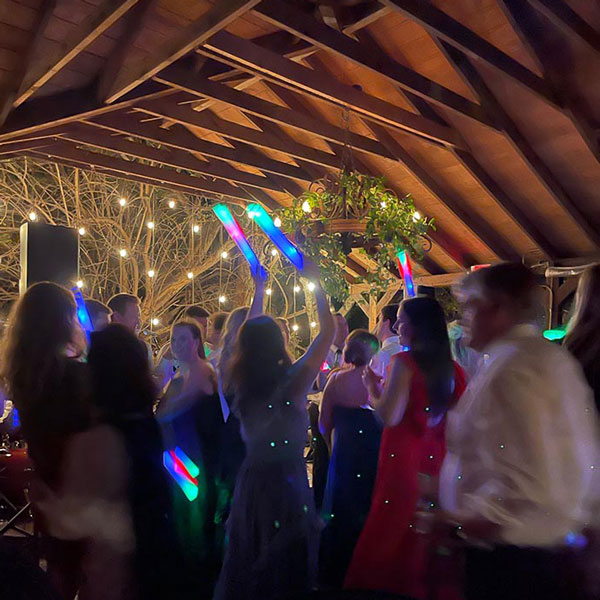 Guests joyfully dancing in a brightly lit room, showcasing professional party planning in Dallas, TX